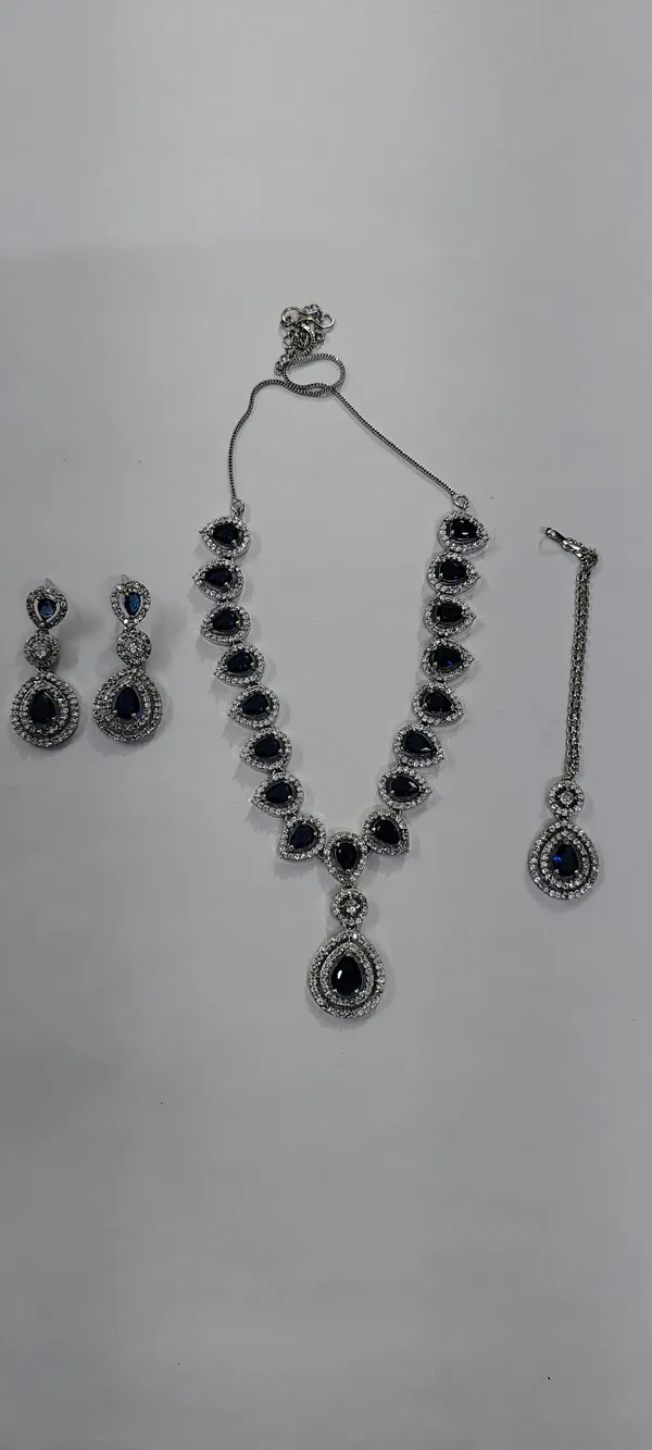 AD_String_Necklace_Set_with_Blue_Stones,_Earrings_and_Tika
Pendant_Style,_Silver_Tone_Finish,_Teardrop_Stones,_3-Piece_Set,