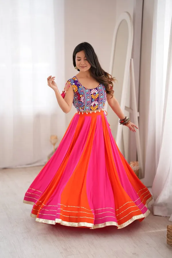 Vibrant_pink_and_orange_multi-paneled_rayon_lehenga_choli_with_a_heavily_embroidered_mirror-work