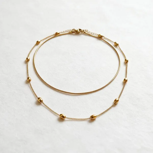 Handmade_Necklace_With_Double_Layer_Graceful_Chains_Having_Delicate_Gold_Tone_Bead_Accents_And_A_Sleek_Curved_Silhouette_(Gold)