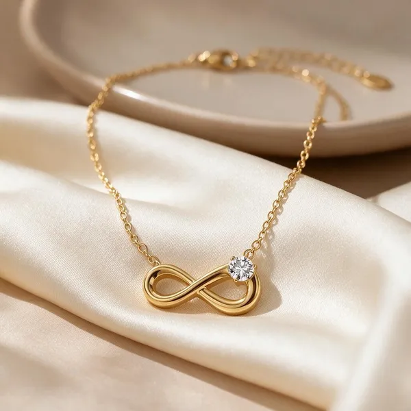 Horizontally_Integrated_Infinity_Symbol_Pendant_Necklace_Detailed_With_Subtle_Linear_Textures_And_Anchored_By_A_Single_Sparkling,_Prong_Set_Solitaire_Stone_Offset_On_The_Loop_(Gold)