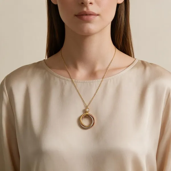 Geometric_Interlocking_Pendant_Necklace_With_Tri_Color_Bands_In_Polished_Gold,_Rose_Gold_And_Silver_Finishes_Suspended_From_A_Brilliant_Bezel_Set_Zircon_Accent