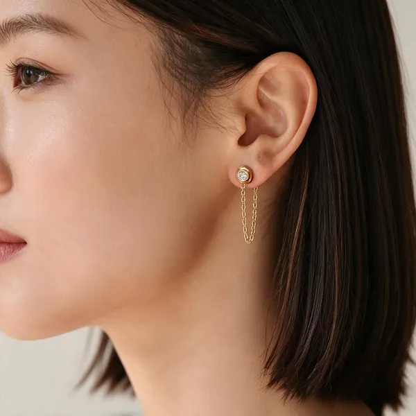 Drop_Earrings_Featuring_A_Bezel_Set_Round_Sparkling_Zircon_Stud_Connected_With_A_Delicate_Gold_Cable_Chain_Loop_Dangles_Beneath_(Single_Stud)