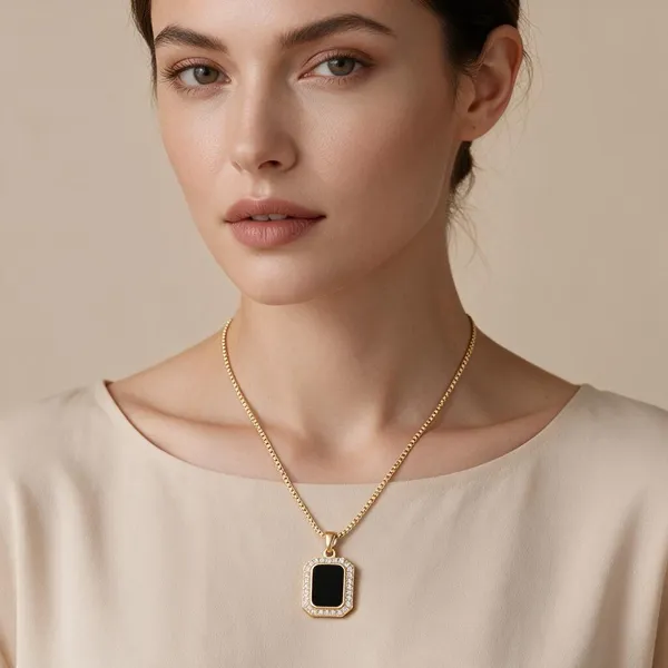 Vacation_Inspired_Pendant_Necklace_Featuring_A_Sleek,_Rectangular_Quadrilateral_Design_With_A_Deep_Black_Onyx_Style_Acrylic_Center_Framed_By_A_Shimmering_Halo_Of_Pave_Set_Cubic_Zirconia_Stones_Suspended_From_An_Elegant_Textured_Chain_(Gold)