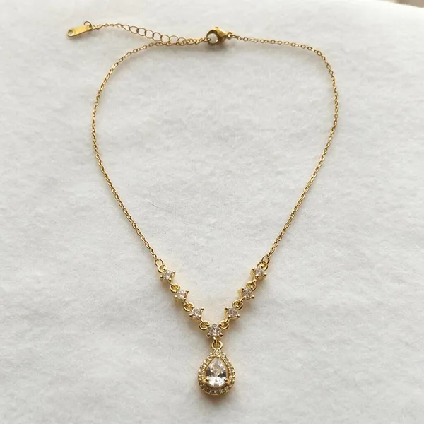 Sparkling_Pear_Cut_Cubic_Zirconia_Stone_Pendant_Necklace_Embellished_With_Graduating_Halo_Set_Zirconia_Stations_Leading_To_The_Main_Drop_Central_Teardrop_(Gold)