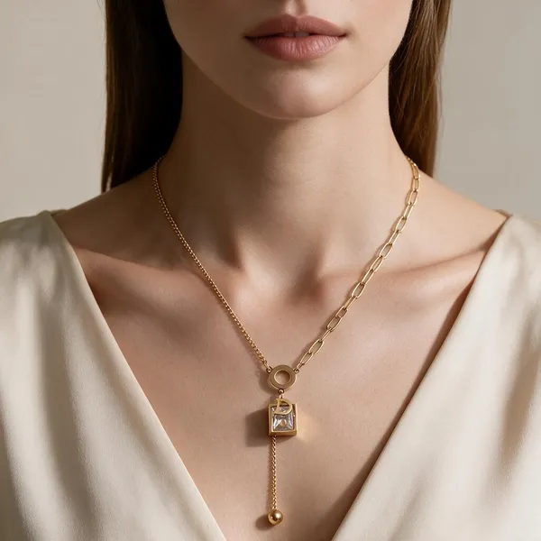 Asymmetric_Dual_Chain_Designer_Lariat_Necklace_Featuring_A_Black_Enamel_O_Ring_Centerpiece,_The_Y_Drop_Silhouette_Featuring_A_Sparkling_Emerald_Cut_5A_Cubic_Zirconia_Pendant_Layered_With_A_Gold_Initial_Letter_"D"_Charm,_Finishing_With_A_Dangling_Gold_Bead_Tassel_Drop_(Gold)