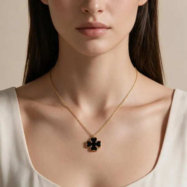 Versatile_Reversible_Iconic_Four_Leaf_Clover_Pendant_Necklace_Featuring_A_2_In_1_Design_Finished_With_A_Sleek_Black_Enamel_Inlay_On_One_Side_And_Radiant_White_Enamel_Inlay_On_The_Other_(Gold)