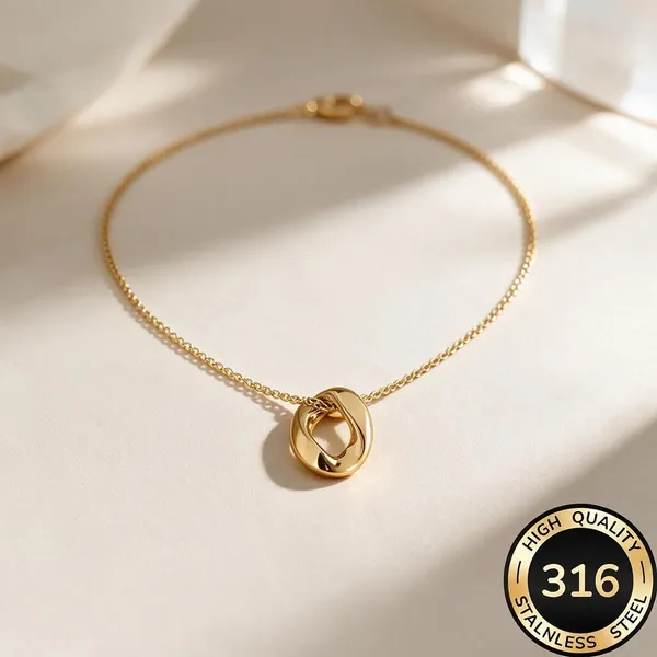 Sculptural,_Mobius_Inspired_Twisted_Oval_Motif_Ring_Pendant_Suspended_Along_A_Delicate_Cable_Chain_(Gold)