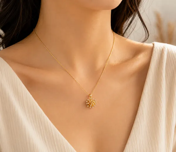 Radiant_Floral_Sunburst_Pendant_Necklace,_crafted_in_316_stainless_steel_with_18K_gold_plating_and_sparkling_crystal_details_(Gold)