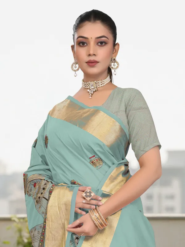 Powder_Blue_Matka_Silk_Portrait_Motif_Saree_For_Women