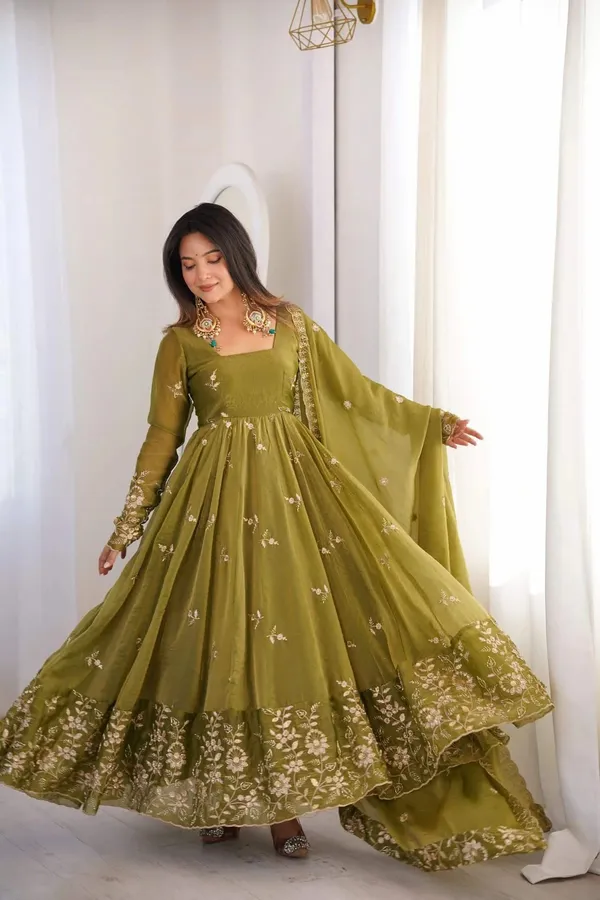 Flared_Olive_Green_Anarkali_Suit_With_Detailed_Floral_Embroidery_Along_The_Hem_And_Sleeves,_Paired_With_A_Matching_Dupatta