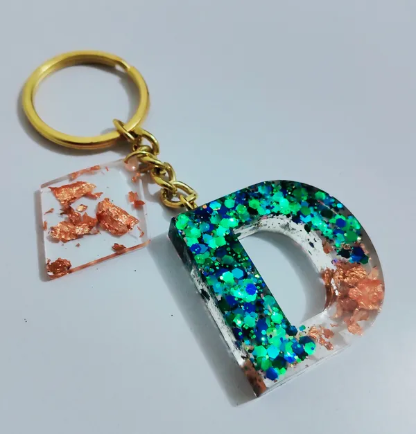 Resin_Alphabate_'A'_Keychain
(Blue_Glitter_&_White_Resin+Golden_Ring+Tessel+Customised_Name_Sticker)