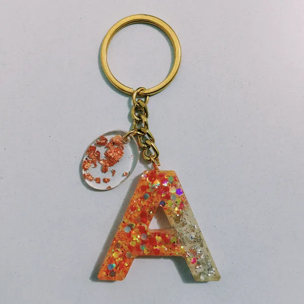 Resin_Alphabate_'S'_Keychain
(Orange_Glitter+Golden_Ring)