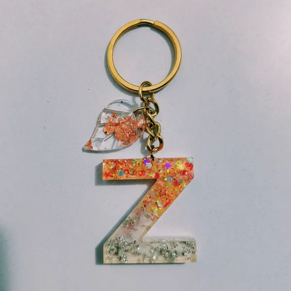 Resin_Alphabate_'S'_Keychain
(Orange_Glitter+Golden_Ring)