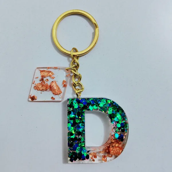 Resin_Alphabate_'A'_Keychain
(Blue_Glitter_&_White_Resin+Golden_Ring+Tessel+Customised_Name_Sticker)