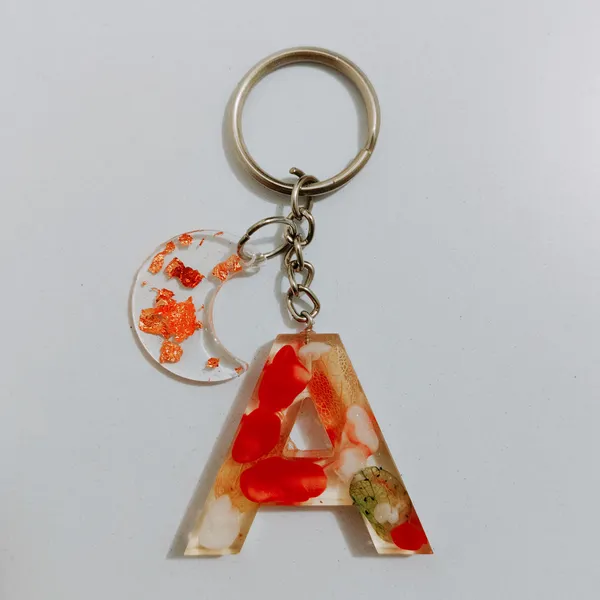 Resin_Alphabate_'A'_Keychain
(Blue_Glitter_&_White_Resin+Golden_Ring+Tessel+Customised_Name_Sticker)