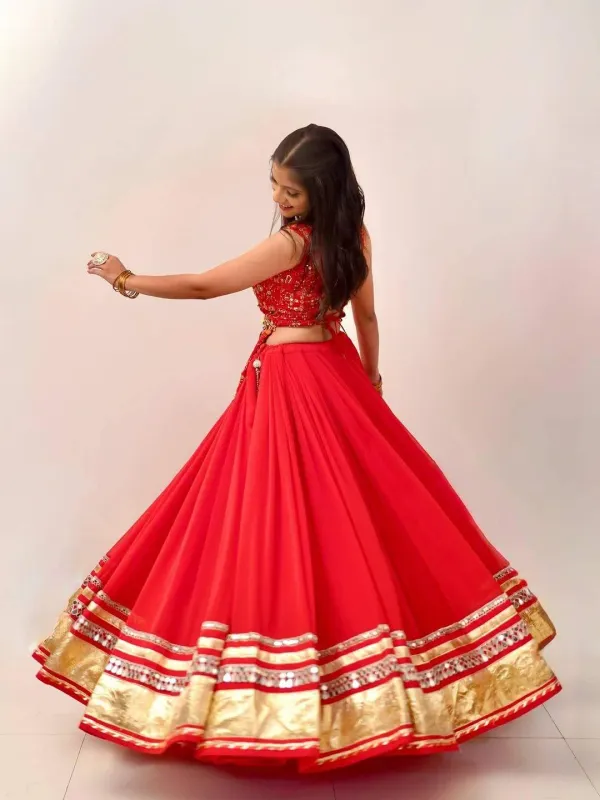 Red_And_Gold_Embellished_Chaniya_Choli_Features_Intricate_Traditional_Mirror_Work_And_Coin_Detailing_Along_The_Waist_And_Hem