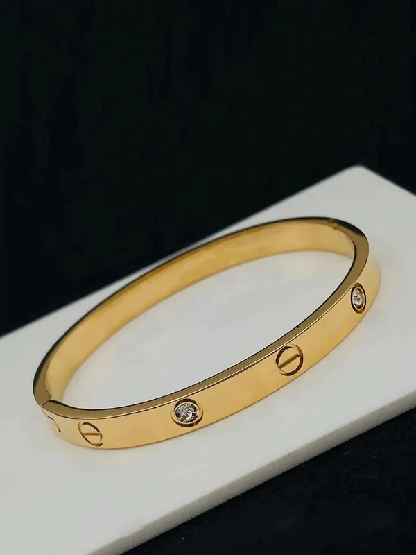Gold_Tone_Screw_Motif_Bangle_For_Women
