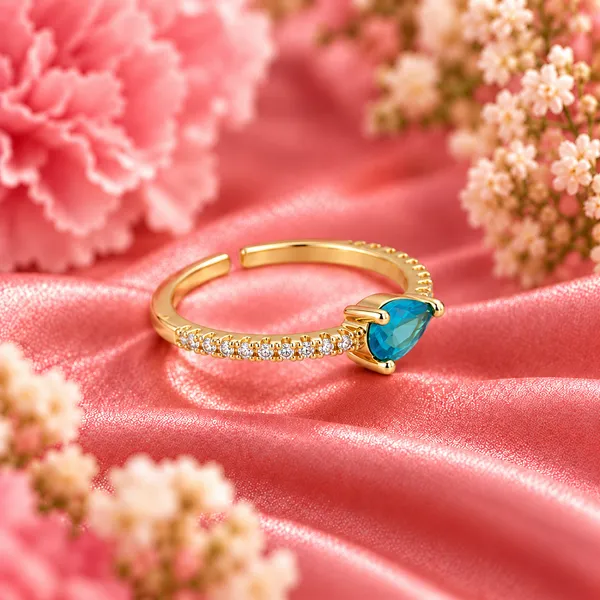 Blue_Pear-Cut_East-West_Pavé_Ring_–_Gold_Tone