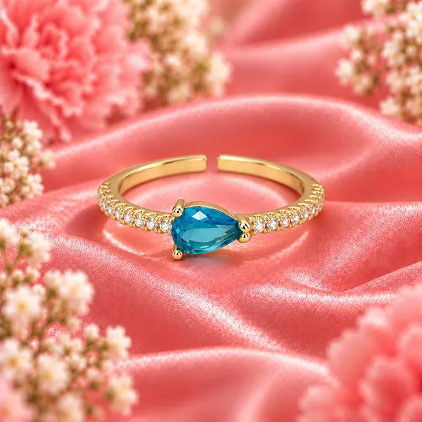 Blue_Pear-Cut_East-West_Pavé_Ring_–_Gold_Tone
