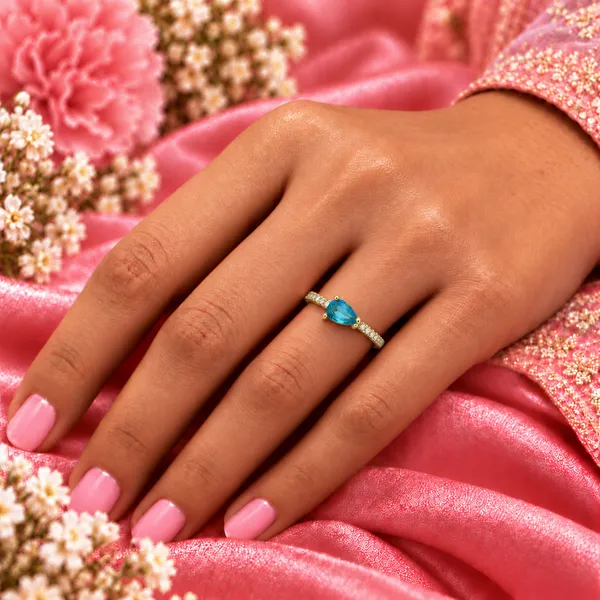 Blue_Pear-Cut_East-West_Pavé_Ring_–_Gold_Tone