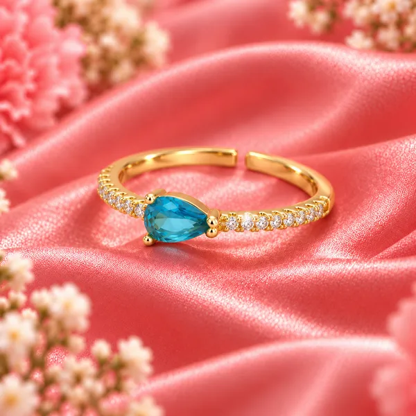 Blue_Pear-Cut_East-West_Pavé_Ring_–_Gold_Tone