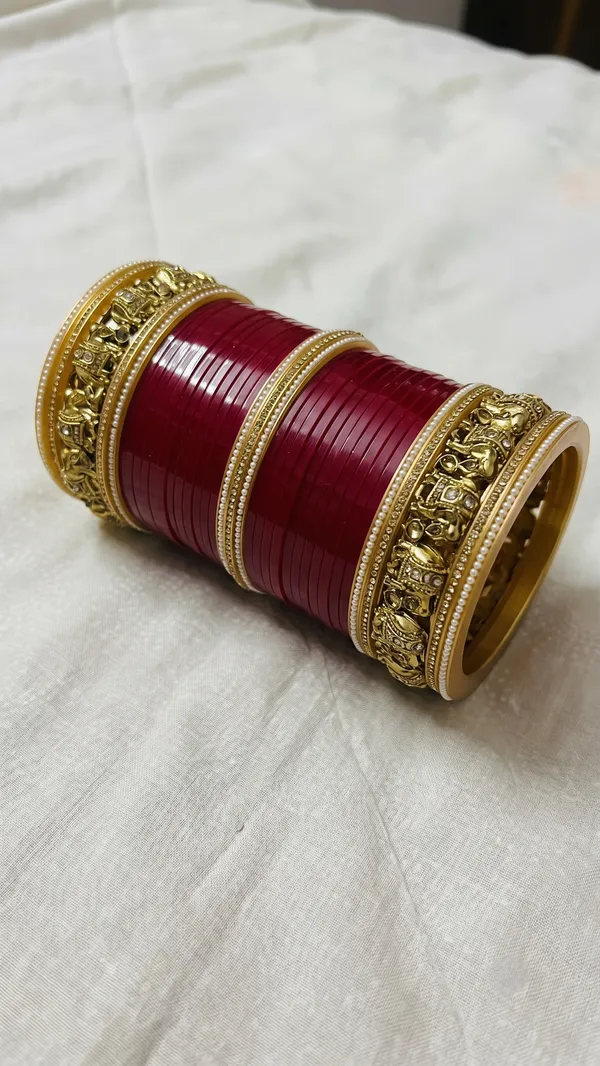 Maroon_Plastic_Gold_Tone_Embellished_Chura_Set_For_Women
