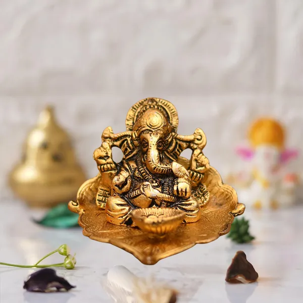 Gold_Lord_Ganesh_Sitting_On_Leaf_With_Diya_Decorative_Showpiece