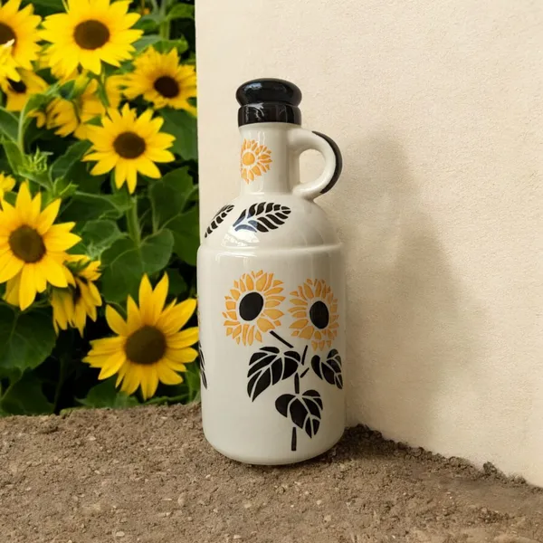 https://d1311wbk6unapo.cloudfront.net/NushopCatalogue/tr:f-webp,w-600,fo-auto/Handcrafted_Ceramic_Sunflower_Design_Oil_Dispenser__Capacity__1000_ML__Size__10_x_25_cm_AA43ZE53SU_2024-07-21_1.jpeg__Madarks