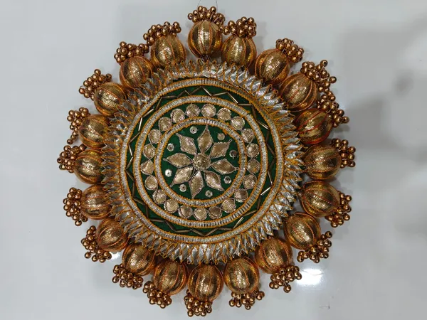 https://d1311wbk6unapo.cloudfront.net/NushopCatalogue/tr:f-webp,w-600,fo-auto/Handmade_DecorativeGota_Ball_Patch__Pooja_Thali__Puja_Plate__Decoratve_Pooja_Plates_for_Festivals__Green__JHSDX21R17_2024-08-01_1.jpeg__Nutts