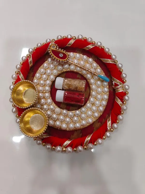 https://d1311wbk6unapo.cloudfront.net/NushopCatalogue/tr:f-webp,w-600,fo-auto/Handmade_Designer_Pearls_Chudi_Decorative_Pooja_Thalis_With_Tilak_Stick__Tilak_Contains_For_Pooja_Festival_G68PN6XTHY_2024-08-01_1.jpeg__Nutts