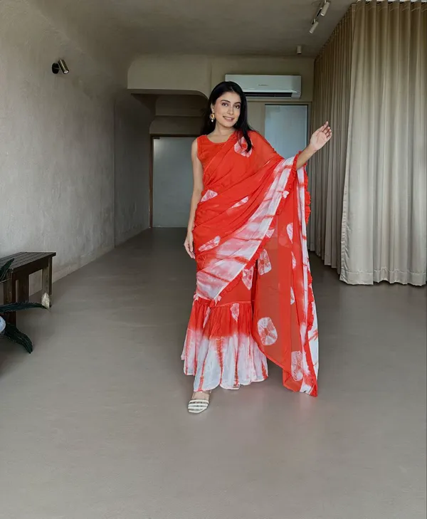 https://d1311wbk6unapo.cloudfront.net/NushopCatalogue/tr:f-webp,w-600,fo-auto/Orange_Tie_Dye_Gown_Saree_S7XKFZ50JM_2024-07-18_1.jpg