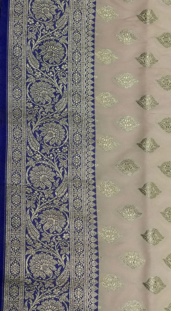 Humairah_Presents_Off-White_Katan_Silk_Floral_Light_Gold_Zari_Booti_with_Contrast_Blue_Floral_Pallu_Banarasi_saree_and_Blue_Blouse