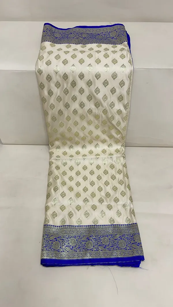 Humairah_Presents_Off-White_Katan_Silk_Floral_Light_Gold_Zari_Booti_with_Contrast_Blue_Floral_Pallu_Banarasi_saree_and_Blue_Blouse