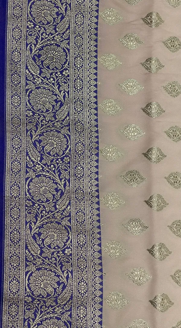Humairah_Presents_Off-White_Katan_Silk_Floral_Light_Gold_Zari_Booti_with_Contrast_Blue_Floral_Pallu_Banarasi_saree_and_Blue_Blouse