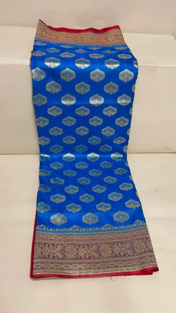 Humairah_Presents_Blue_Satin_Silk_Silver_Zari_Floral_Boota_and_Contrast_Red_Zari_Border_and_Heavy_Silver_Zari_Floral_Anchal_Banarasi_Saree_with_Red_Blouse