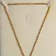Traditional Antique Gold finish with Emerald Green center, Ruby Red stone accents, and gold-beaded c